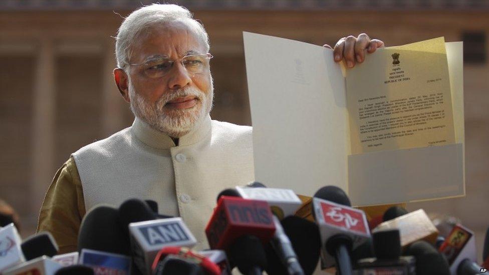 In this Tuesday, May 20, 2014 file photo, India"s Prime Minister-elect Narendra Modi displays the letter from the Indian president inviting him to form the new government