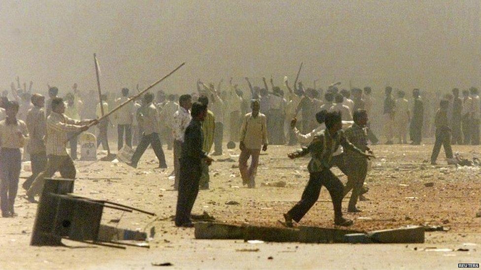 Indian Hindus riot in the smoke-shrouded streets of Ahmedabad, the main city in the western Indian state of Gujarat in this March 1, 2002 file photo. Narendra Midi's critics depict him as an autocratic Hindu supremacist who would tyrannize the country's minority Muslims if his Bharatiya Janata Party (BJP) came to power. Modi himself insists he is a moderate who will create a prosperous India for people of all creeds. Picture taken March 1, 2002.