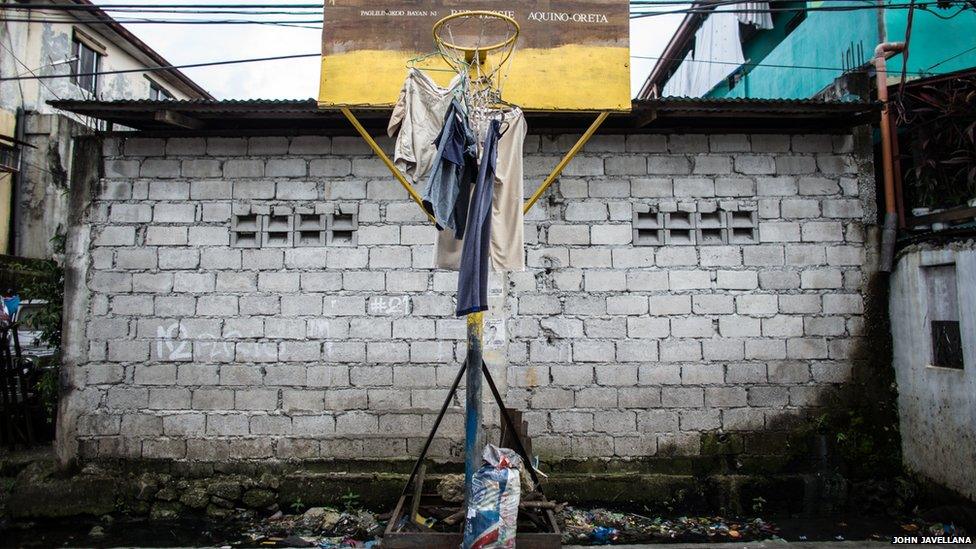 Clothes are hung out to dry at a basketball court in the slum area of Artex, Malabon Philippines.