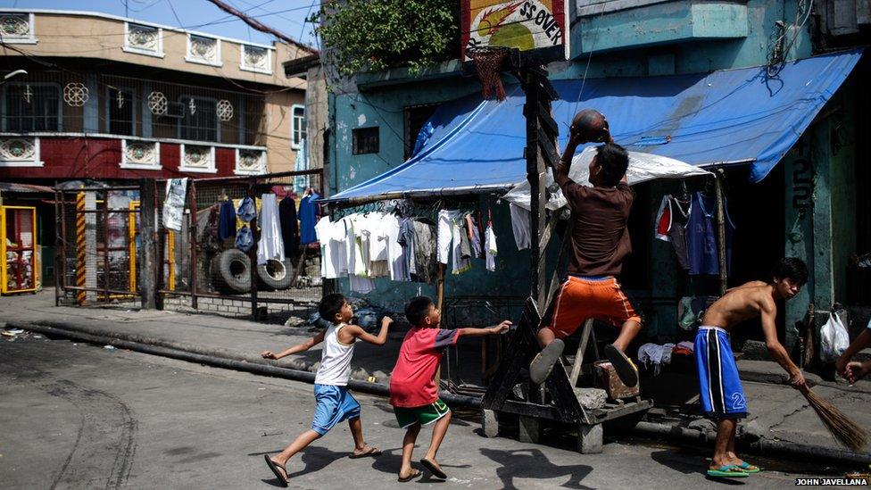 Children play at a makeshift basketball court in the slum are of Tondo, one of the most densely populated areas of Metro Manila, Philippines.