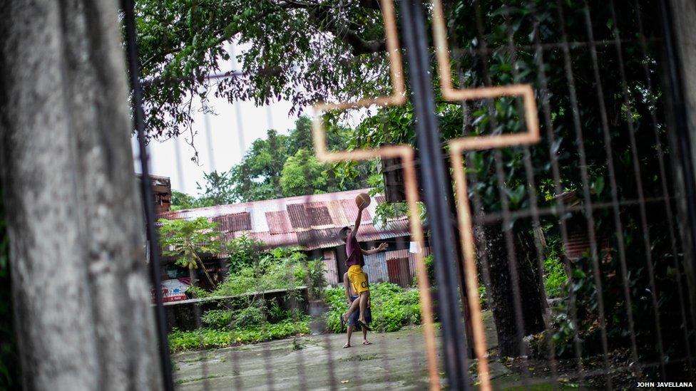 Children play at a basketball court inside the premises of a church in Samar, south of the Philippines