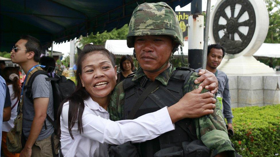 A pro-government demonstrator embraces a Thai soldier on the outskirts of Bangkok - 23 May 2014