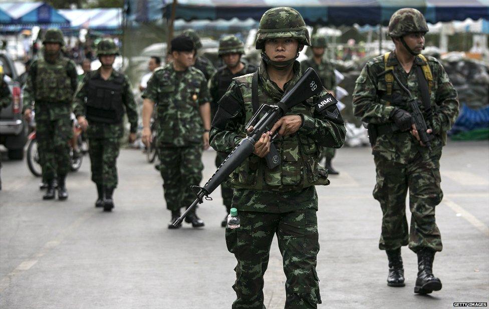 Thai soldiers walk through a market in central Bangkok - 23 May 2014