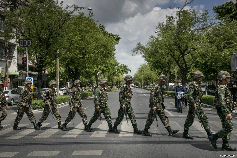 A line of Thai soldiers march over a crossing on a street in central Bangkok - 23 May 2014