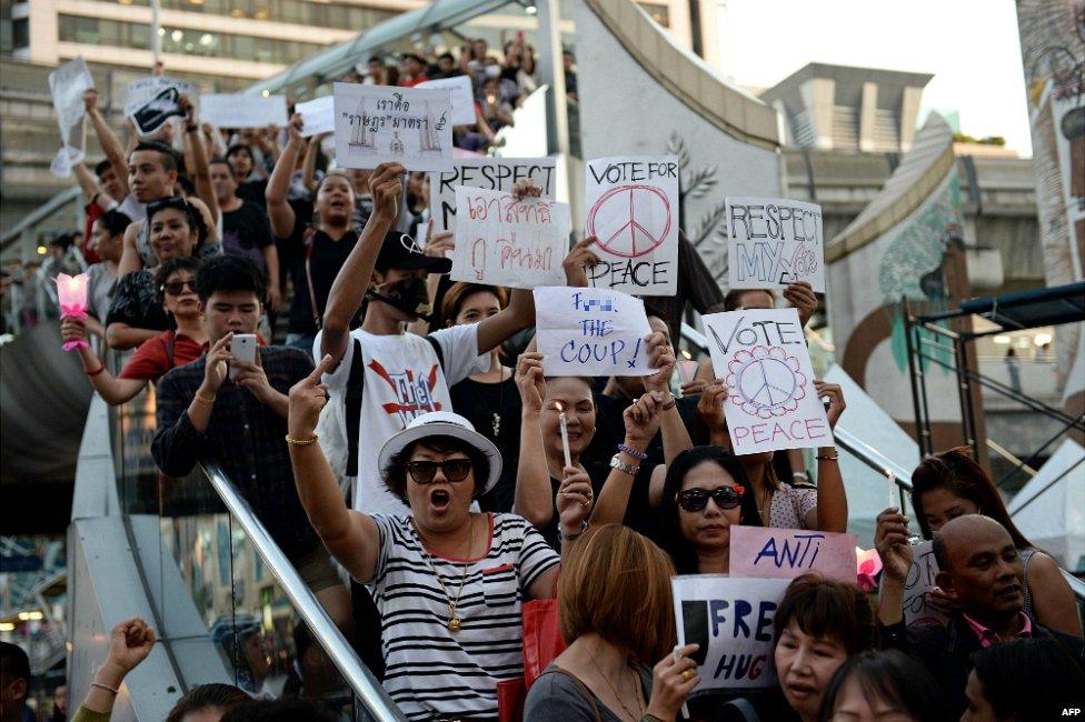 Anti-coup activists hold signs as they gather to protest against the actions of the Thai army in downtown Bangkok - 23 May 2014