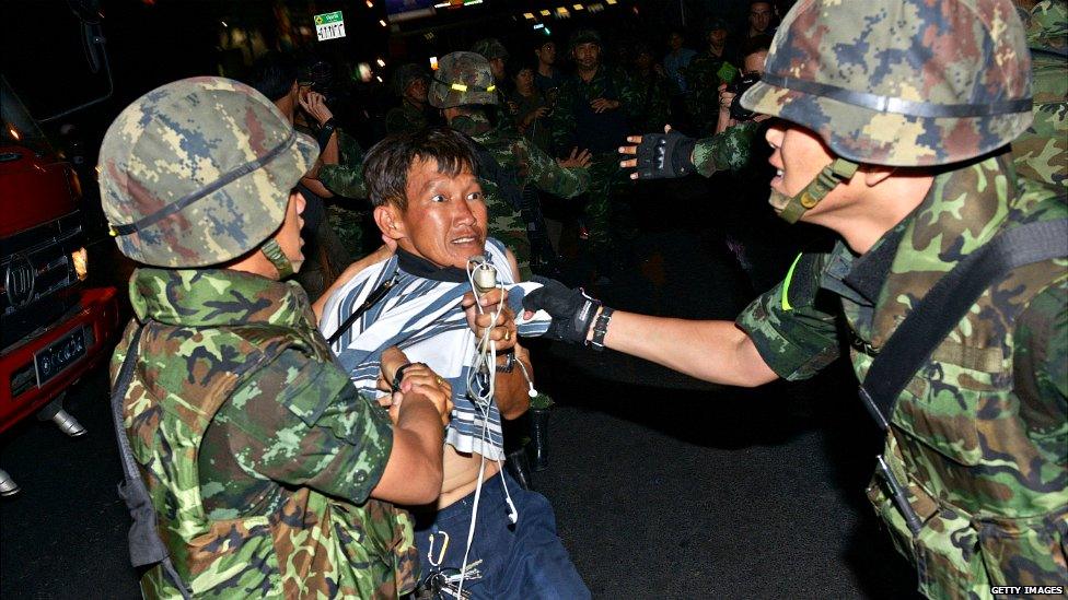 A protester is dragged away by Thai army soldiers after taking part in an anti-coup rally in Bangkok - 23 May 2014