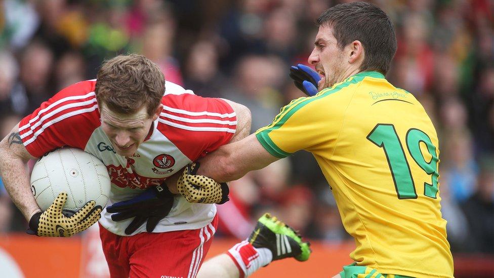 Enda Lynn of Derry is challenged by Donegal opponent Paddy McGrath during the Ulster Championship clash at Celtic Park