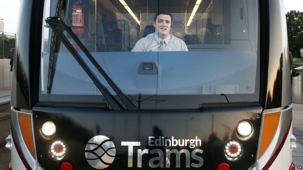 Craig Scotland drives the first tram carrying paying passengers at the Gyle shopping centre in Edinburgh.