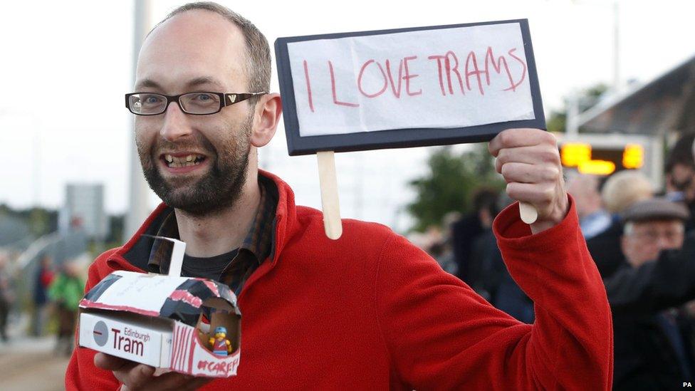 Tram enthusiast with sign "I love trams"