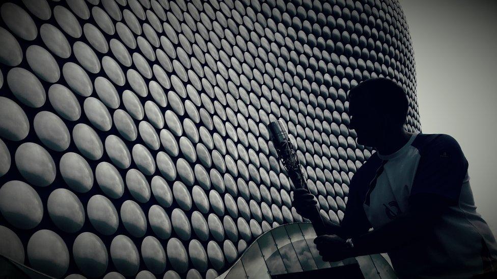 Silhouette of baton-bearer in front of Selfridges at the Bullring, Birmingham