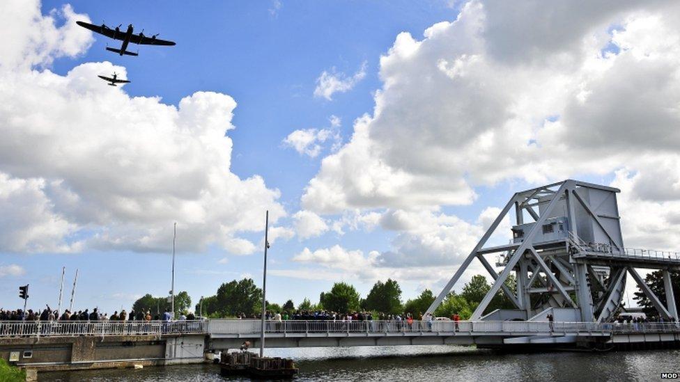 Spitfire and a Lancaster flying over Pegasus Bridge