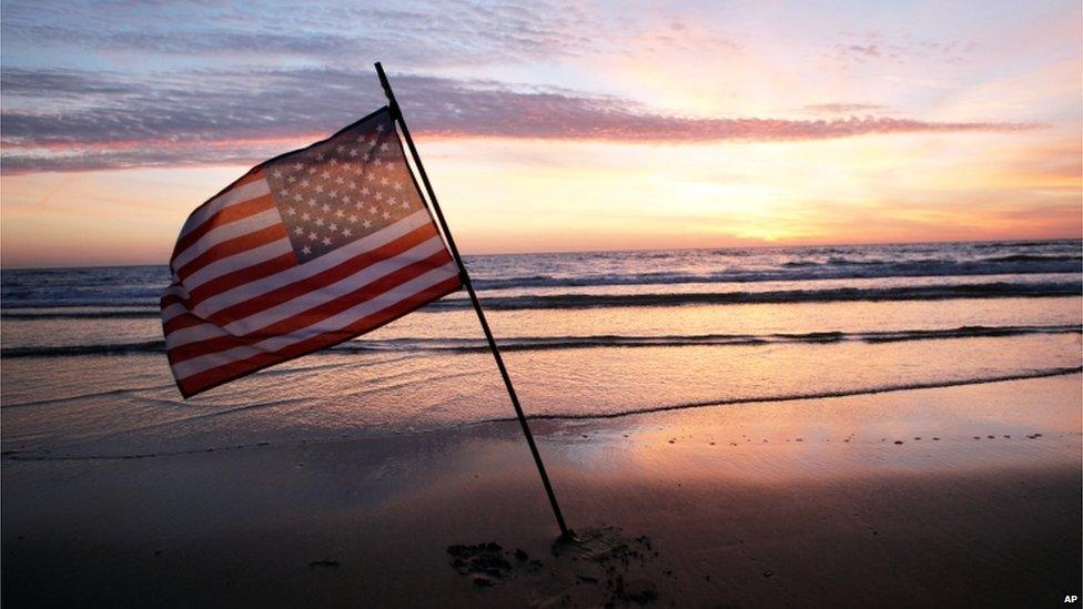 A US flag planted on a beach