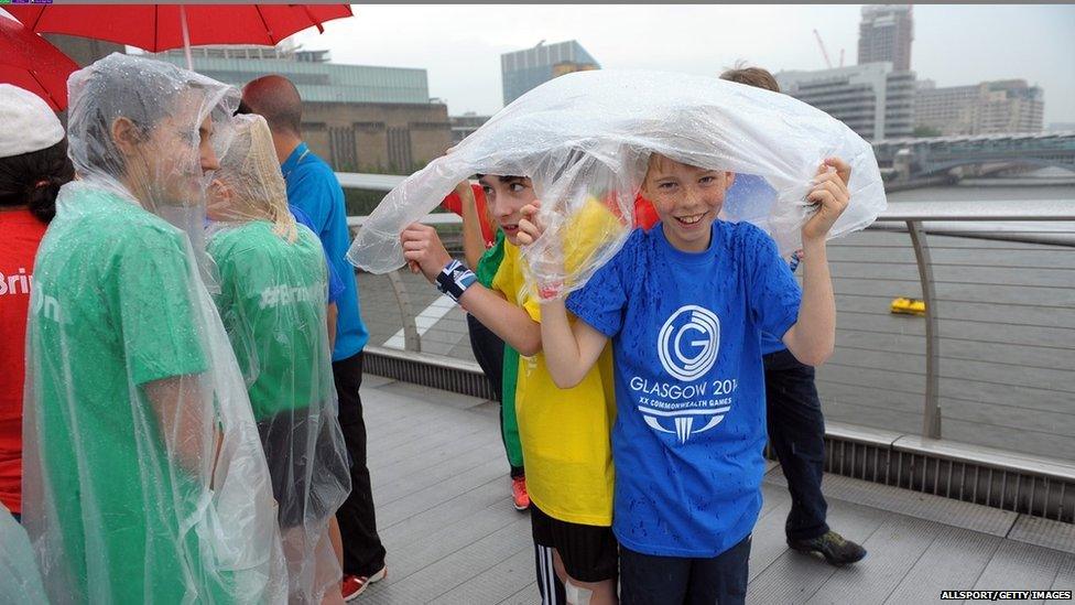 Lambeth school children take shelter from the rain on the Millennium Bridge