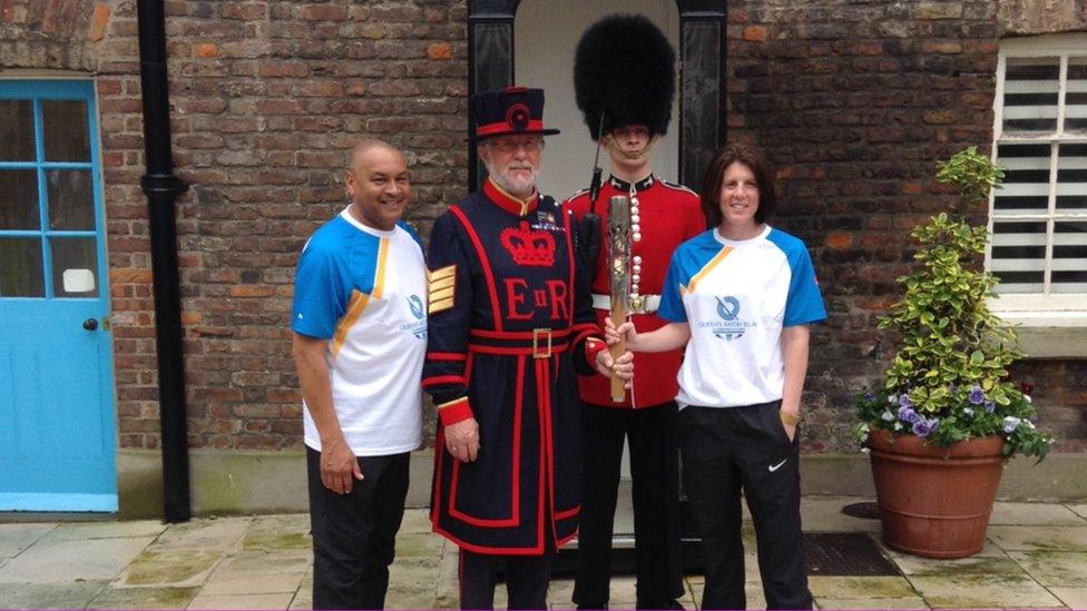 Baton bearers Brian at Rebecca at the Tower of London with a Yeoman and soldier