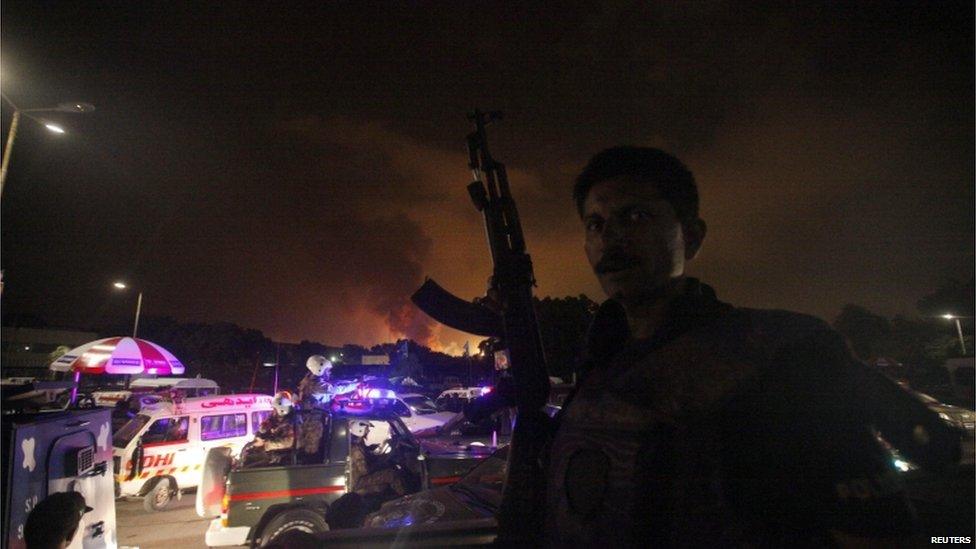 A policeman with a gun stands guard near Karachi's airport