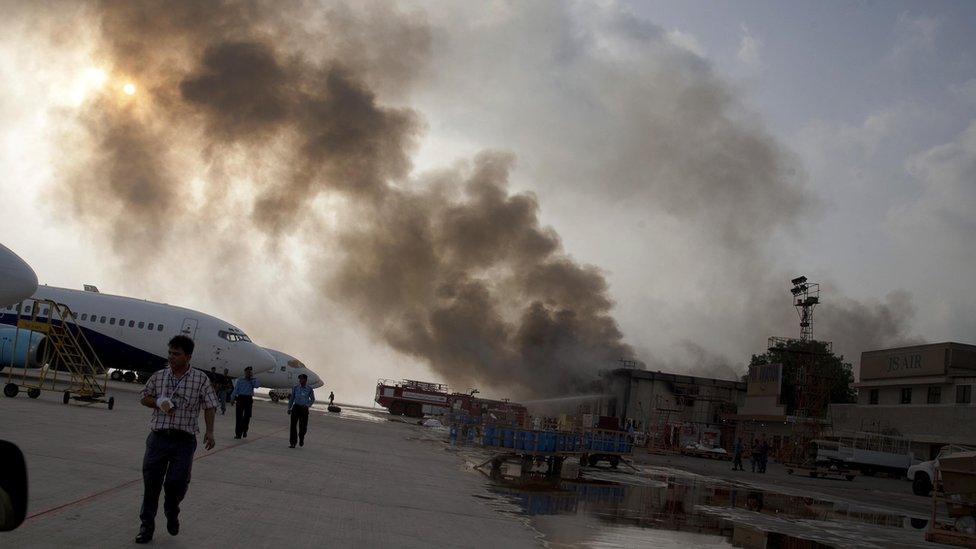 Smoke rises above Jinnah airport, Karachi (9 June)