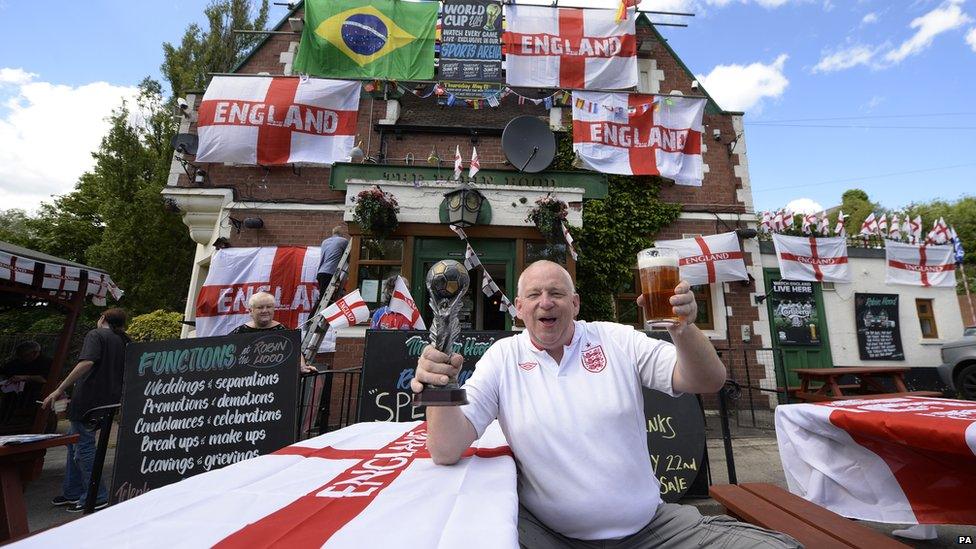 Landlord Robin Scott of The Robin Hood pub in Jarrow near South Shields, Tyne and Wear, who has adorned his pub with flags of the nations of the 2014 World Cup.