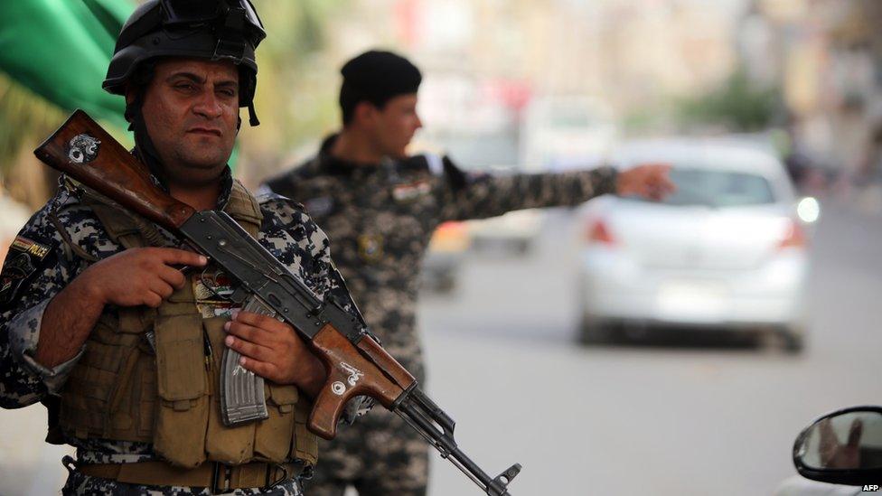 Iraqi policemen man a checkpoint in the capital Baghdad on 10 June 2014, after a state of emergency was declared by the government