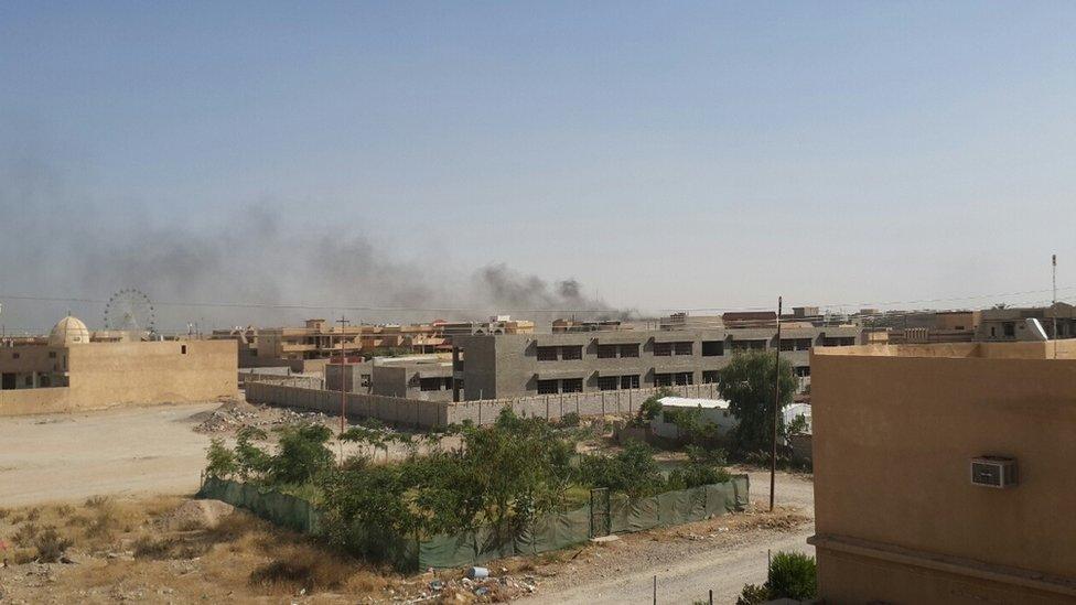 Smoke rises over the city of Tikrit