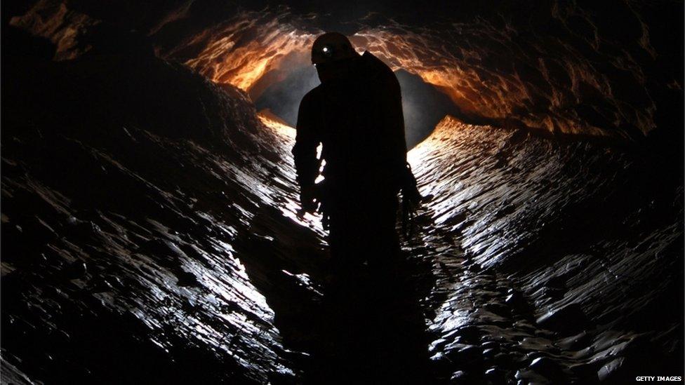 A spelunker explores the Riesending cave near Marktschellenberg, Germany