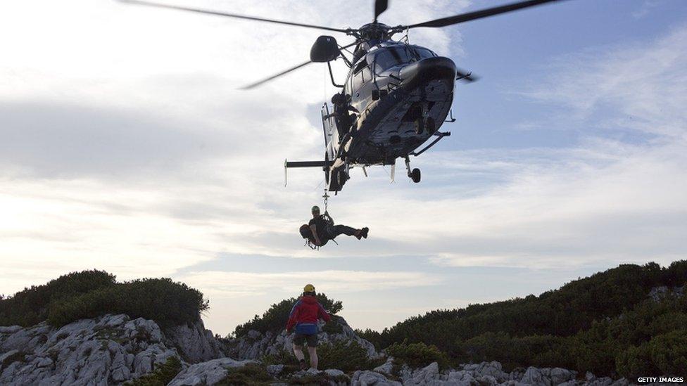 A helicopter delivers rescuers near the entrance to the the Riesending cave