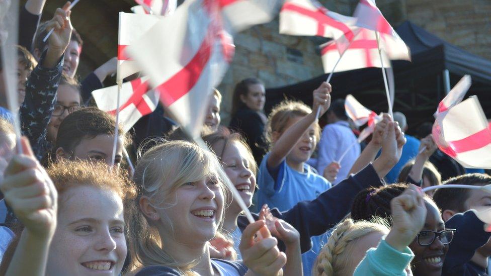 Children wave England flags in Kent