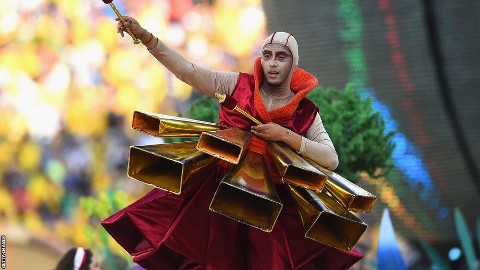 A performer pays tribute to Brazil's musical heritage during the opening ceremony for the World Cup at the Arena de Sao Paulo