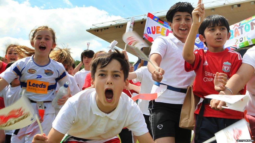 Children wait for baton-bearer Nile Wilson (not pictured) to arrive with the Queen's Baton at the John Charles Centre for Sport on 12 June 2014 in Leeds