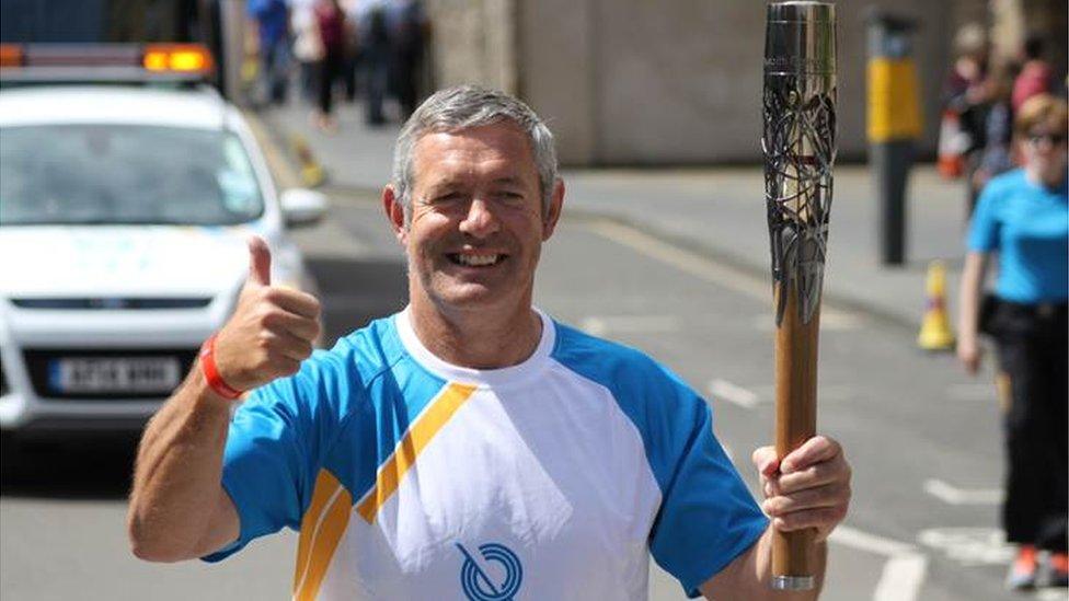 Former Scottish rugby captain Gavin Hastings carried the baton on the Royal Mile