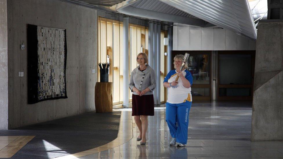 Lynne McNicoll, who has raised thousands of pounds for children with cancer, took the baton for a tour of the Scottish Parliament with presiding officer Tricia Marwick