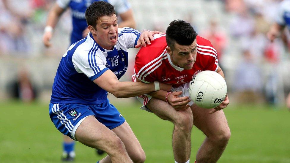 Gerard McCaffrey of Monaghan attempts to dispossess Tyrone's Darren McCurry during the Ulster Championship quarter-final at Clones