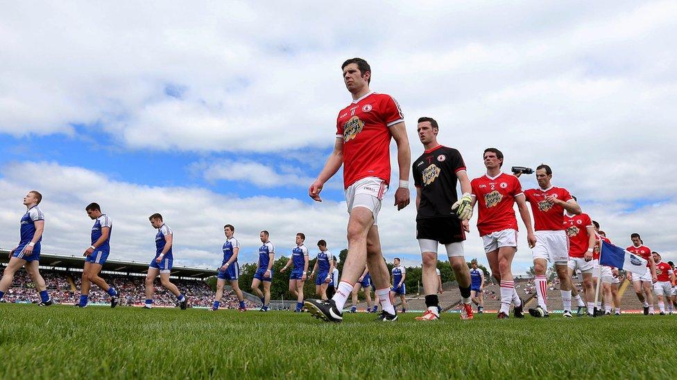 The players of Monaghan and Tyrone pictured during the traditional pre-match parade around the pitch at Clones