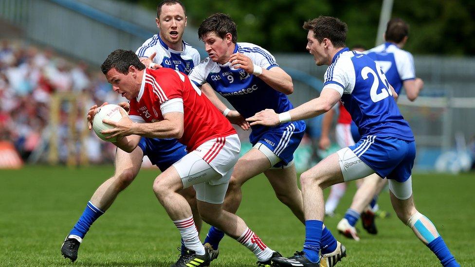 Conor Gormley of Tyrone has his work cut out getting away from Monaghan opponents Vinny Corey, Darren Hughes and Conor McManus