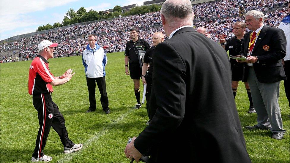 Tyrone manager Mickey Harte confronts referee Eddie Kinsella about the amount of time added on at the end of the match