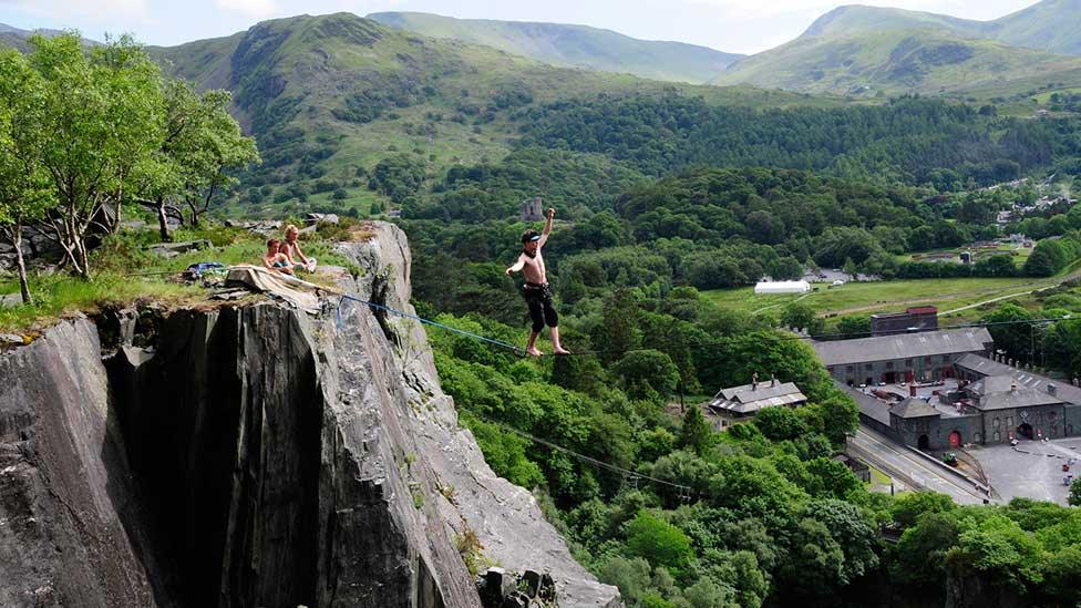 Slacklining over the void of the Vivian Quarry at Padarn Country Park, Llanberis