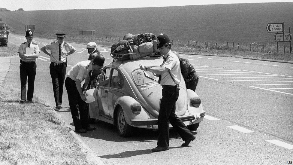 Police hand out keep-away leaflets as they turn away travellers bound for Stonehenge in an effort to stop hippies gathering at the monument to celebrate the summer solstice in 1989.