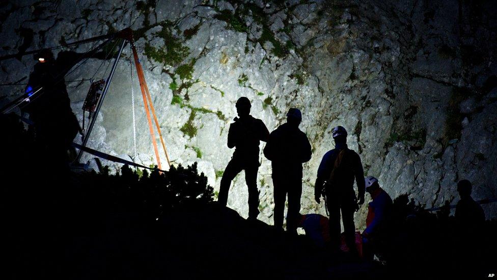 Members of mountain rescue service stand next to the entrance of the Riesending cave near Marktschellenberg, southern Germany. 19 June 2014