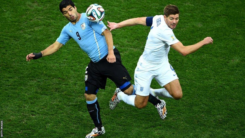 Uruguay's Luis Suarez (left) in action against England captain Steven Gerrard