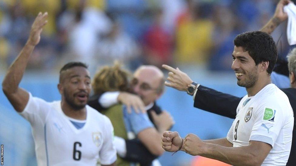 Uruguay forward Luis Suarez (right) celebrates their victory at the end of a Group D football match between Italy and Uruguay at the Dunas Arena in Natal