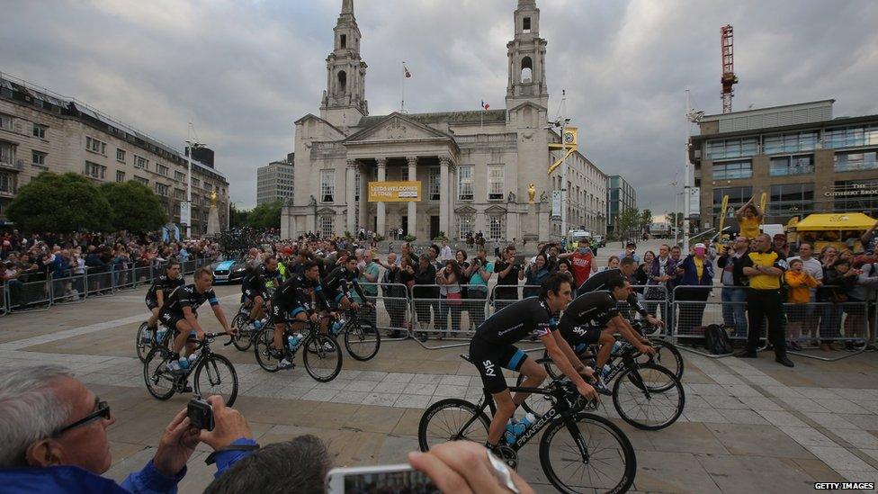 Team Sky is greeted by supporters as they ride through Millenium Square en-route to the Team Presentation prior to the 2014 Le Tour de France. (Photo by Doug Pensinger/Getty Images)