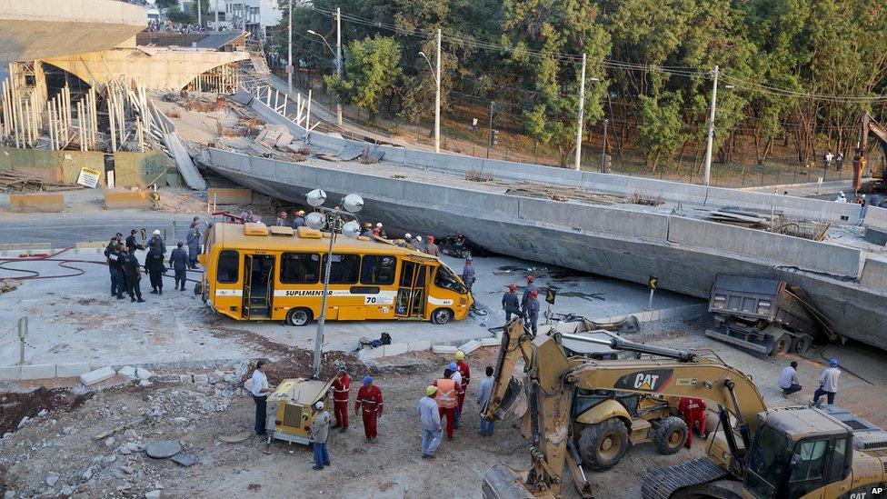 A bus sits damaged next to a bridge after it collapsed in Belo Horizonte, Brazil, on 3 July 2014.