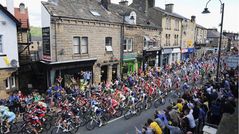 The Tour de France peloton rides through the centre of Ilkley