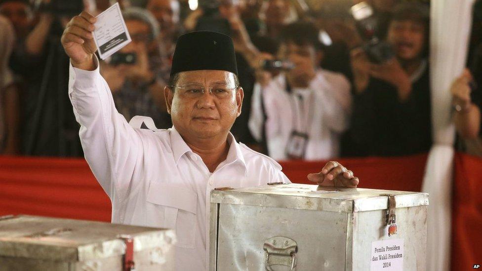 Indonesian presidential candidate Prabowo Subianto shows his ballot paper before voting in the presidential election at a Bojong Koneng polling station in Bogor, Indonesia, on Wednesday, 9 July 2014