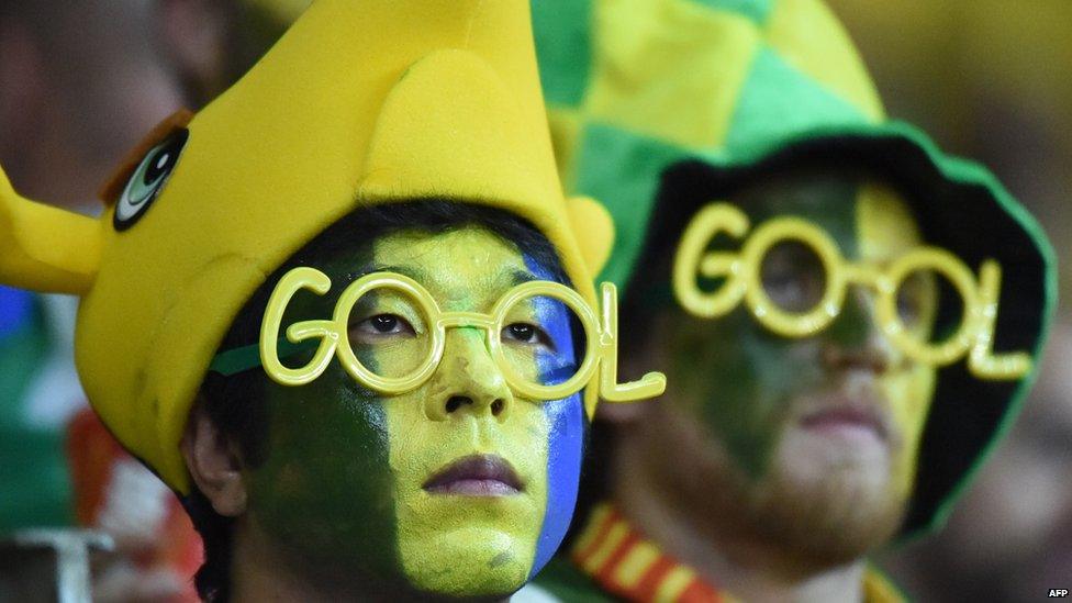 Brazilian fans react at the end of the semi-final football match between Brazil and Germany at on 8 July 2014.