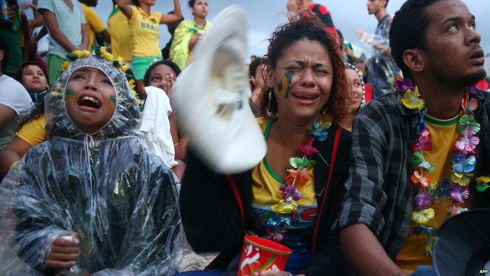 Crying Brazil fans while watching the first half on Copacabana Beach during the 2014 FIFA World Cup semi-final match between Brazil and Germany on 8 July 2014