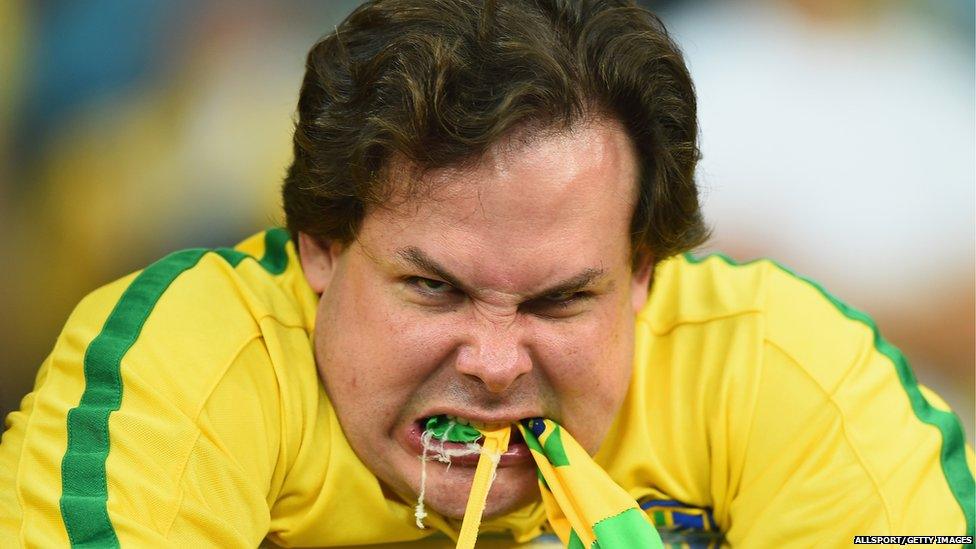 An emotional Brazil fan reacts after being defeated by Germany 7-1 on 8 July 2014