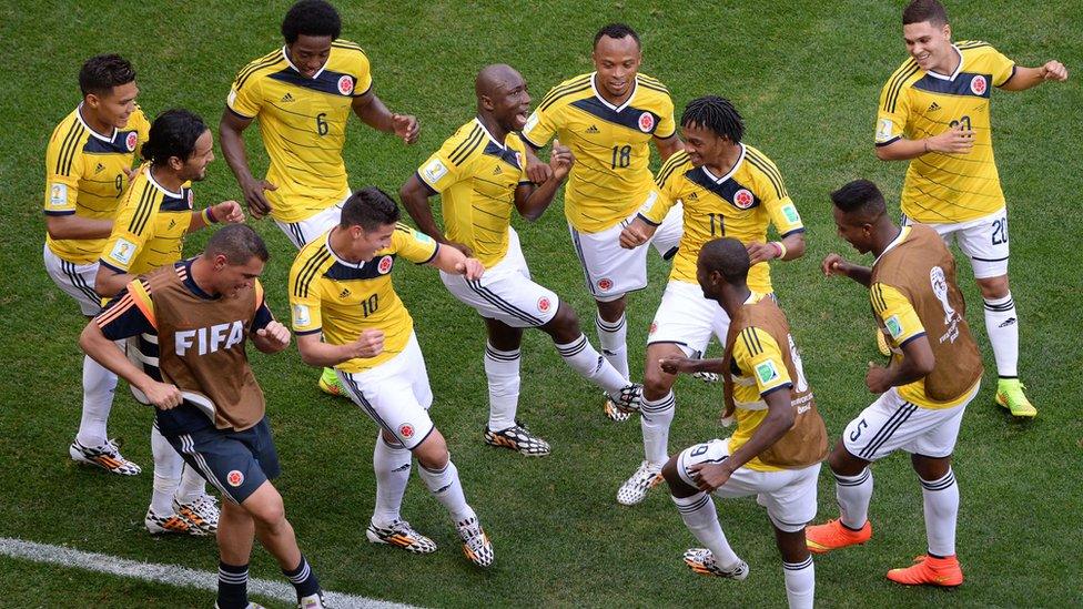 Colombia's players dance after scoring a goal during the Group C football match between Colombia and Ivory Coast at the Mane Garrincha National Stadium in Brasilia