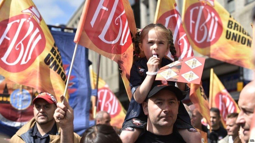 Public sector worker Scott Clarke with six-year-old daughter Amber Clarke during a march through Newcastle city centre.