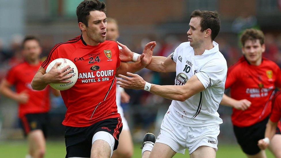 Conor Toney of Down attempts to fend off Kildare opponent Cathal McNally during the game at Newry