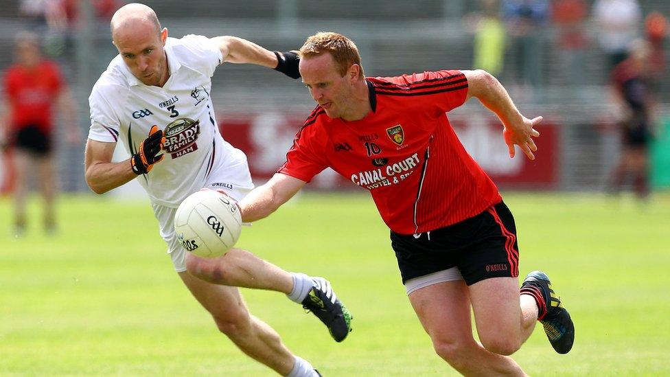 Hugh McGrillen of Kildare tries to close down Down dangerman Benny Coulter